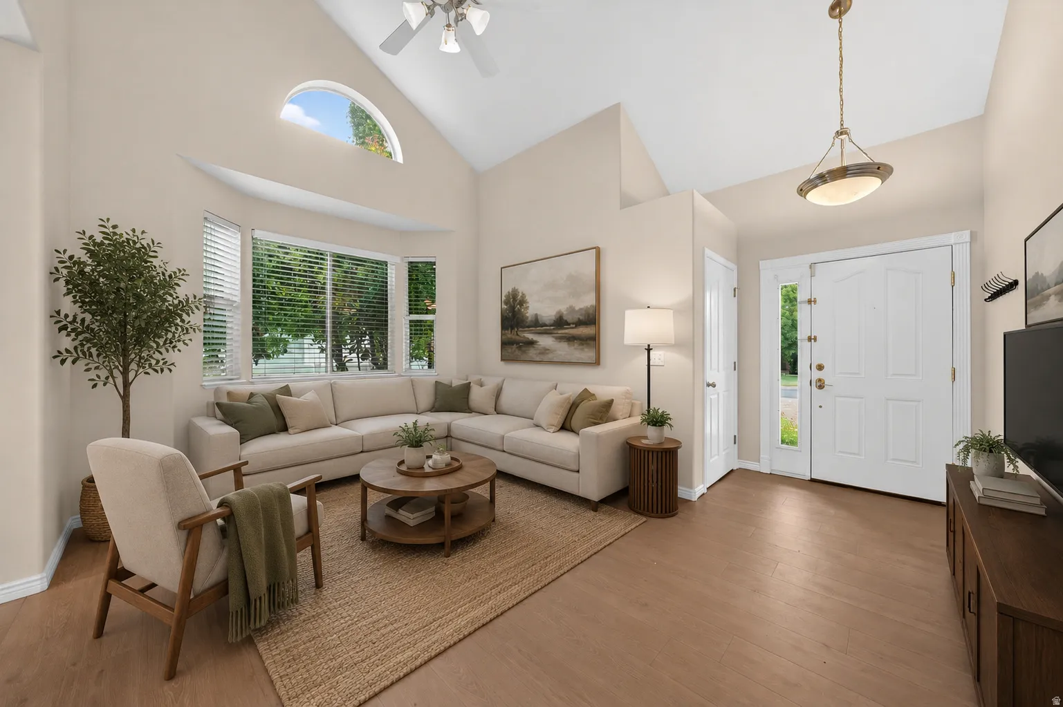 Vaulted ceiling featuring a ceiling fan, bay window with blinds, and wood-finish flooring