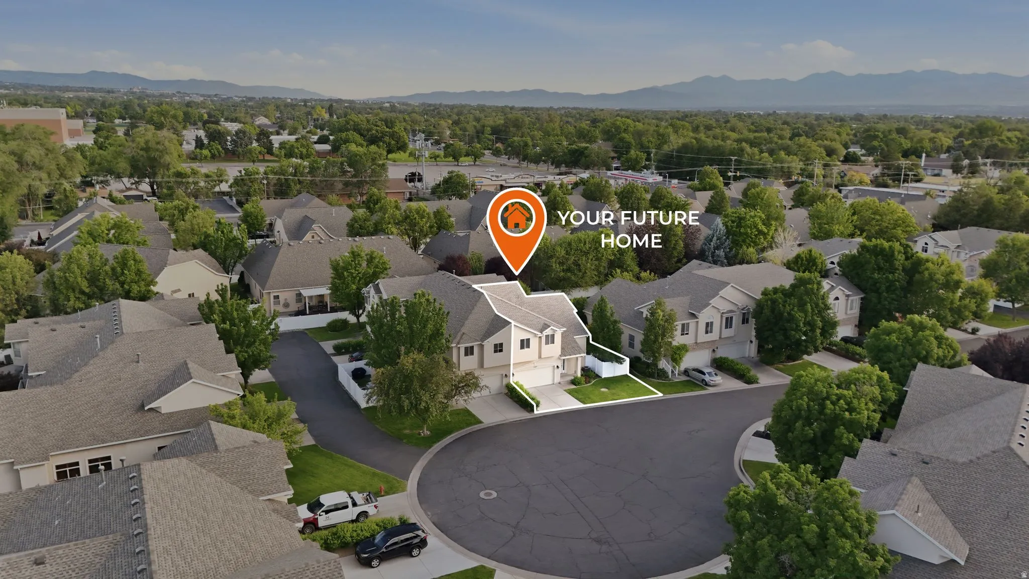 Residential property situated on a cul-de-sac, featuring a two-story design, an attached garage, and a manicured lawn