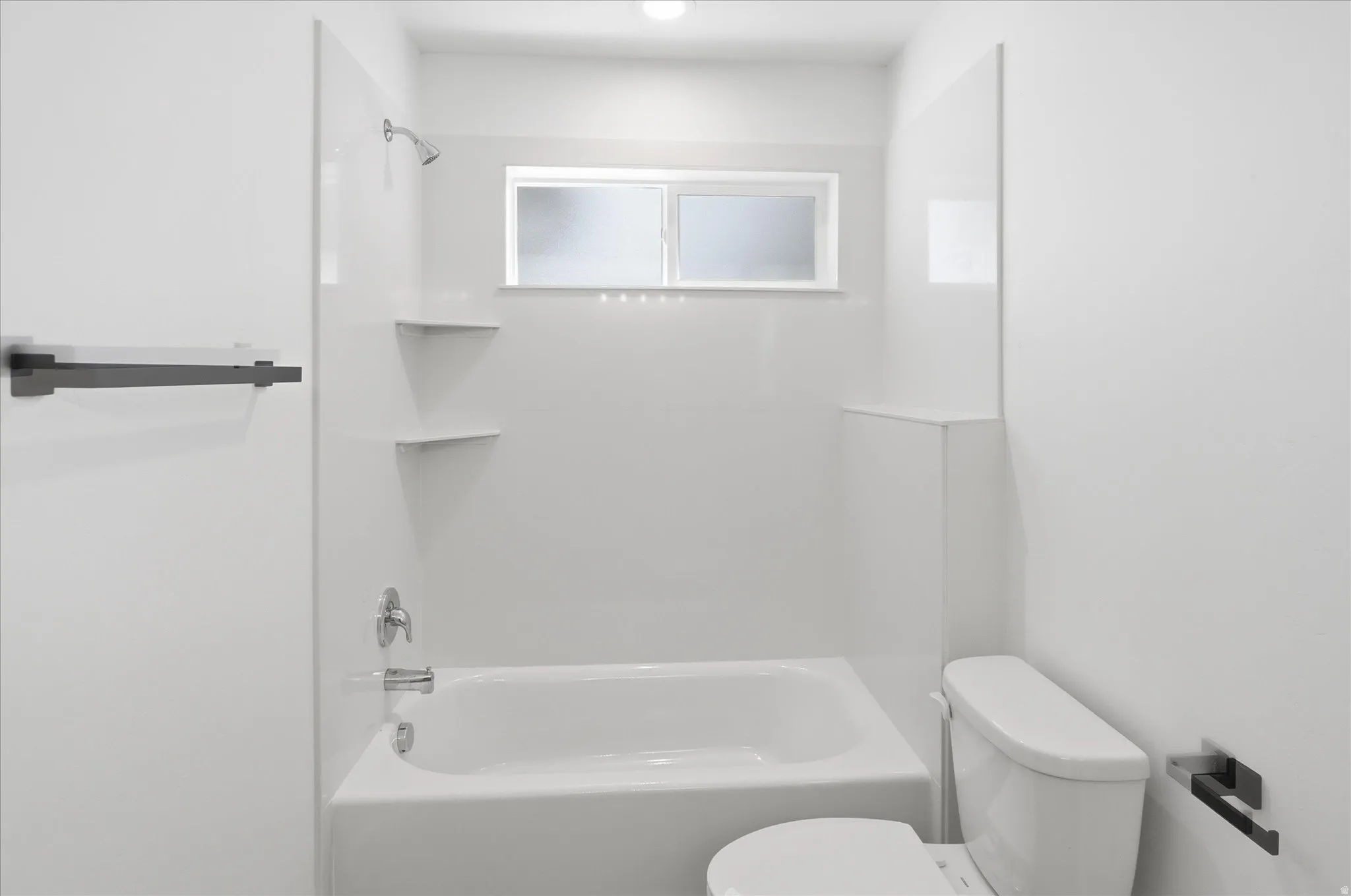 Bathroom with white bathtub and shower surround