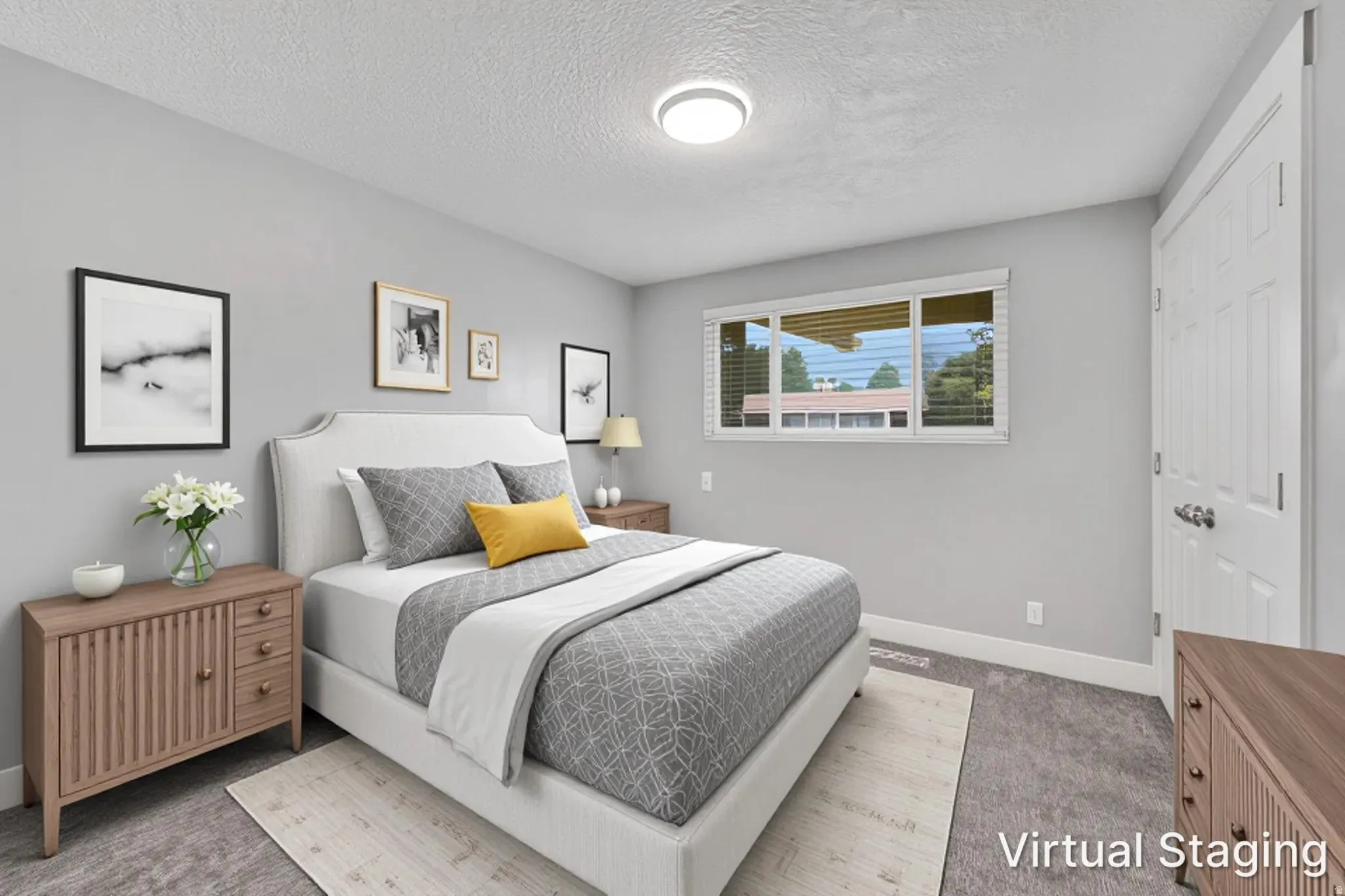 Bedroom featuring neutral gray walls and carpeting, a window with white blinds, a white paneled door, and a flush-mount ceiling light