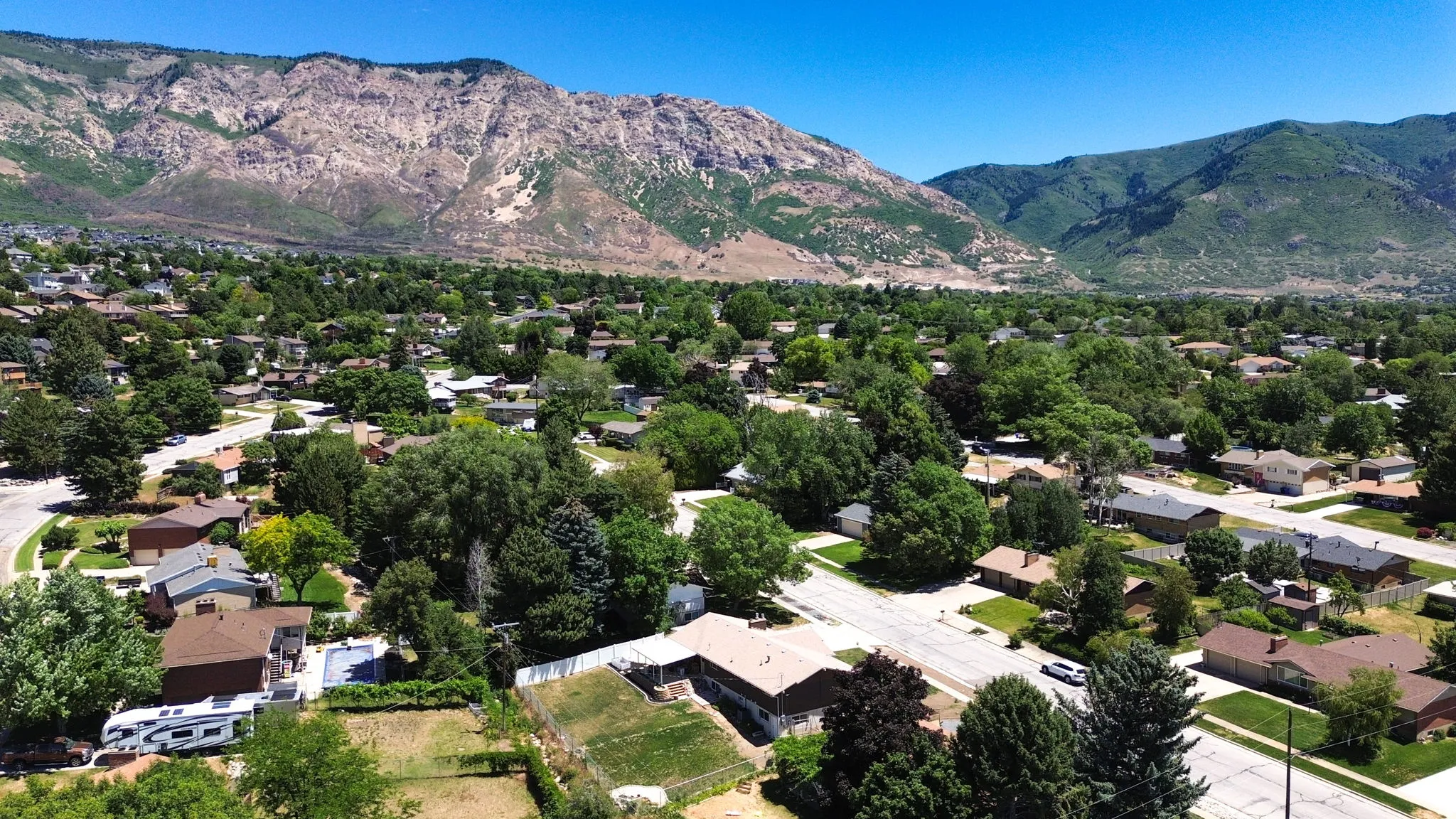 Residential community with established landscaping and mountain backdrop