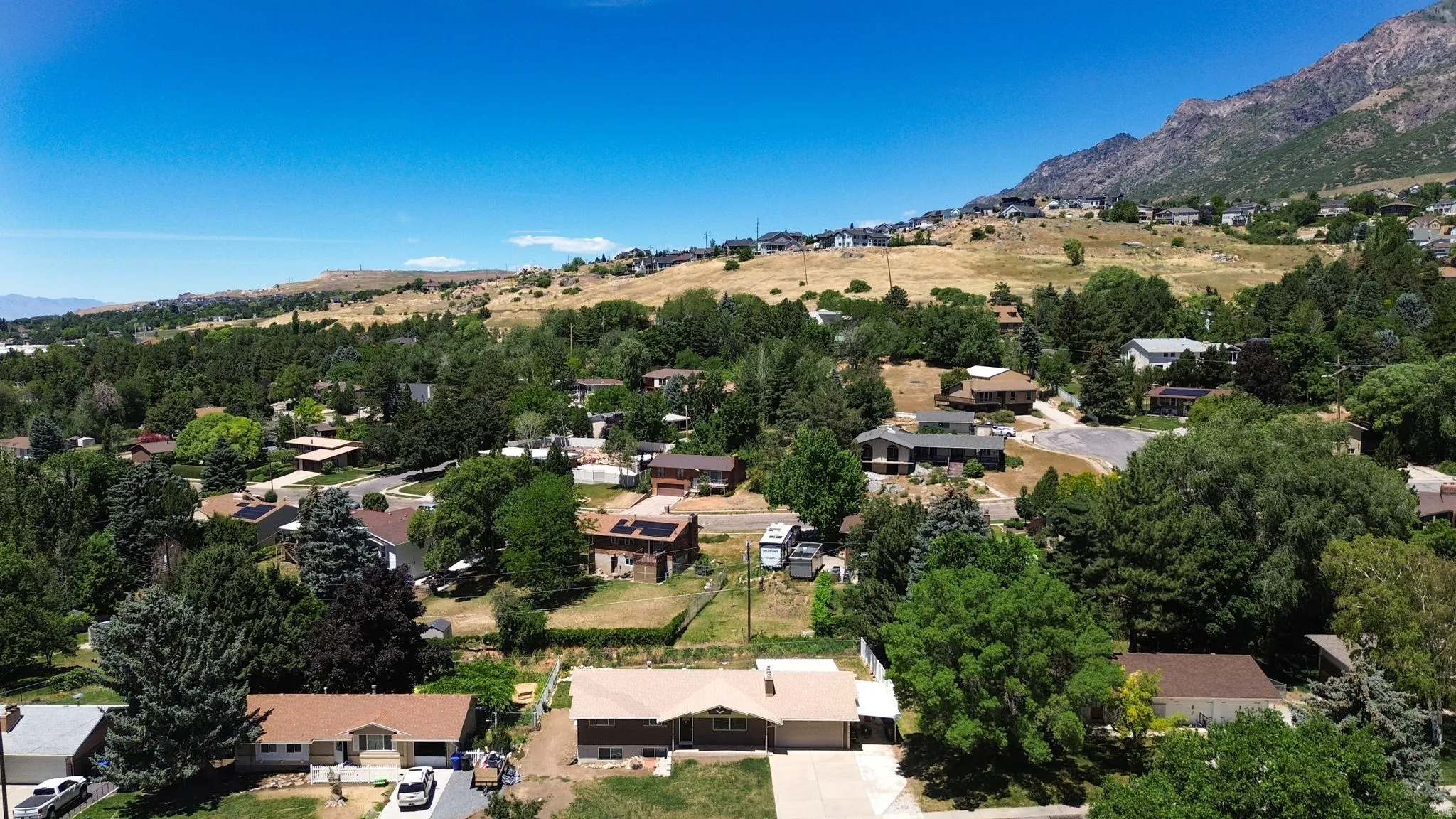 Aerial neighborhood perspective featuring a residential area with varied home styles