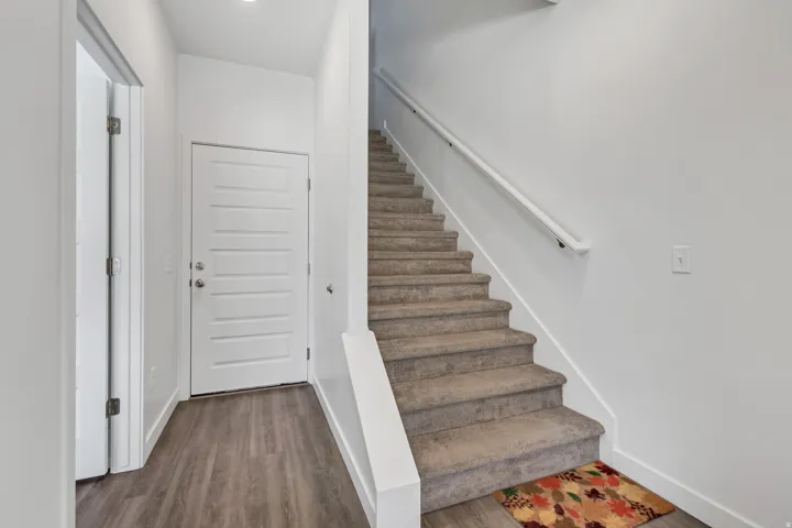 Entryway featuring wood-finish flooring and a contemporary five-panel entry door