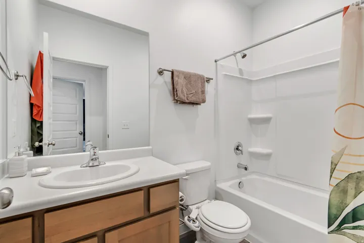 Bathroom featuring a single vanity with wood-finish cabinetry and a white countertop