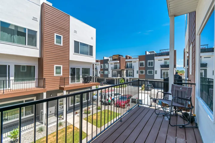Private balcony featuring composite decking and black metal railings