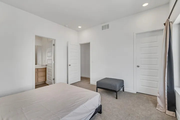 Carpeted room with recessed lighting and a window featuring a curtain rod