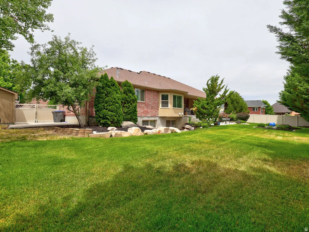 Expansive green lawn with mature trees and established landscaping