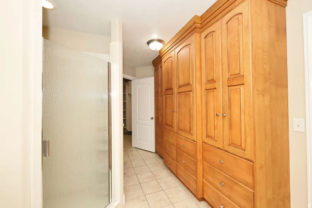 Built-in wood cabinetry with chrome hardware provides extensive storage