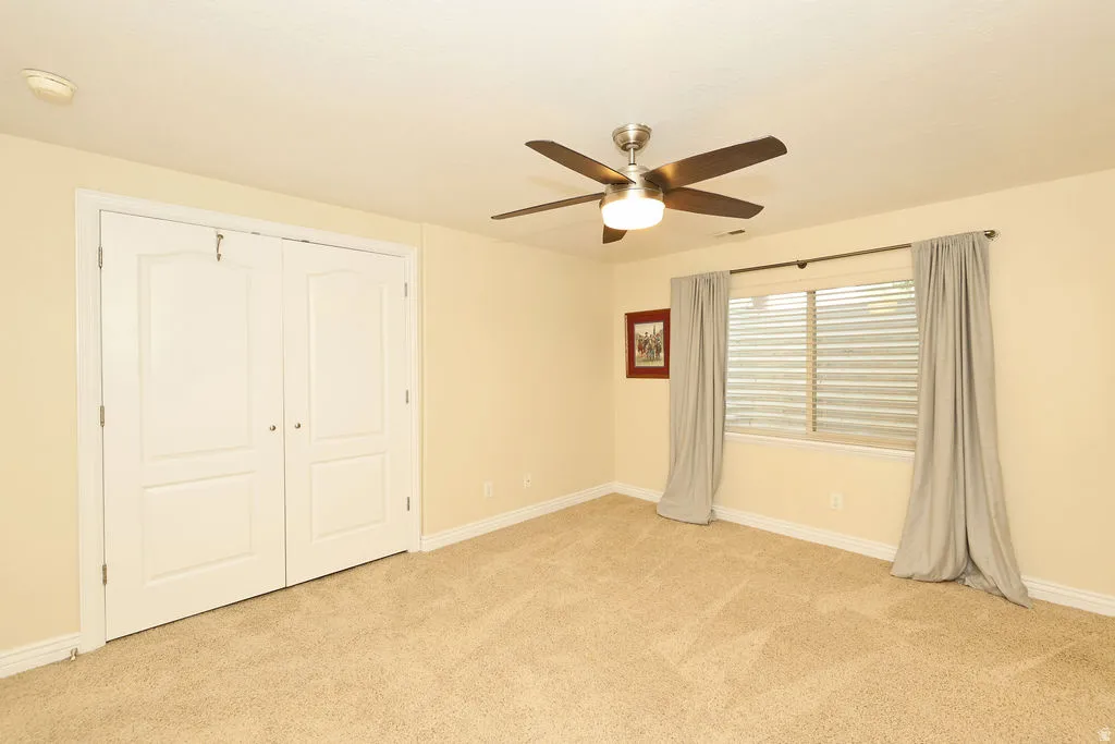 Room featuring light-colored carpeting and pale yellow walls