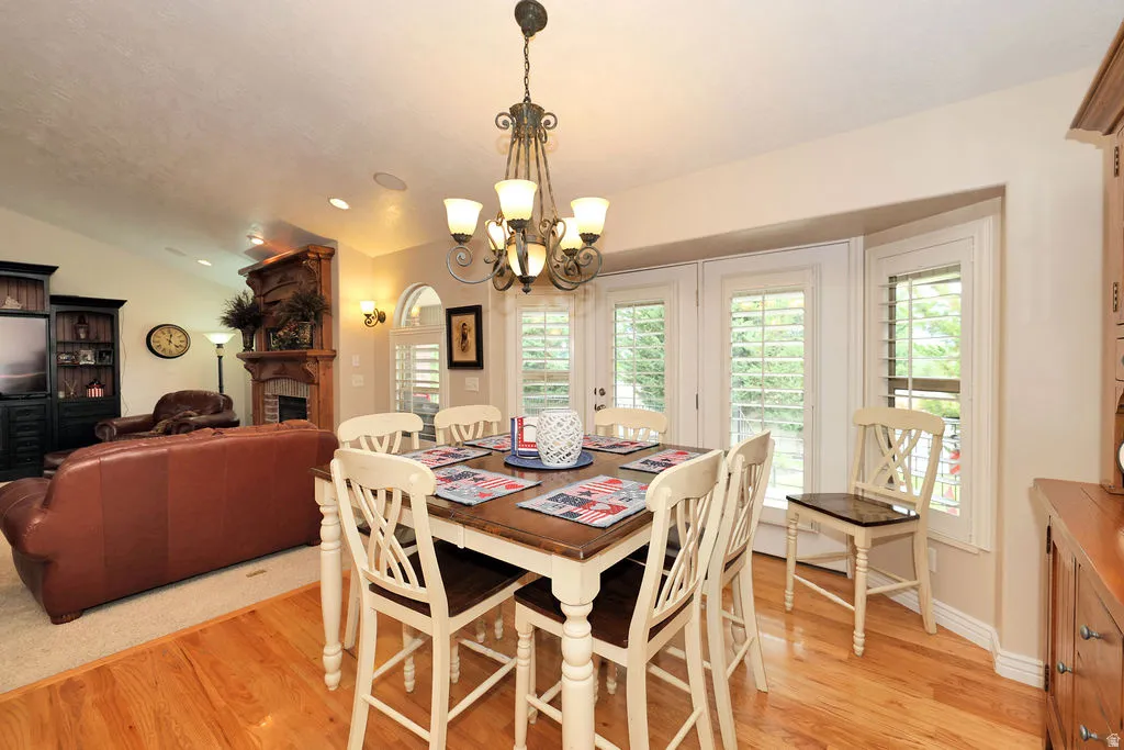 Open-concept dining and living space featuring wood-finish flooring and recessed lighting
