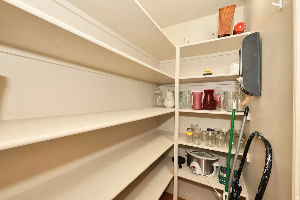 Walk-in pantry featuring multiple levels of built-in shelving, providing extensive storage capacity