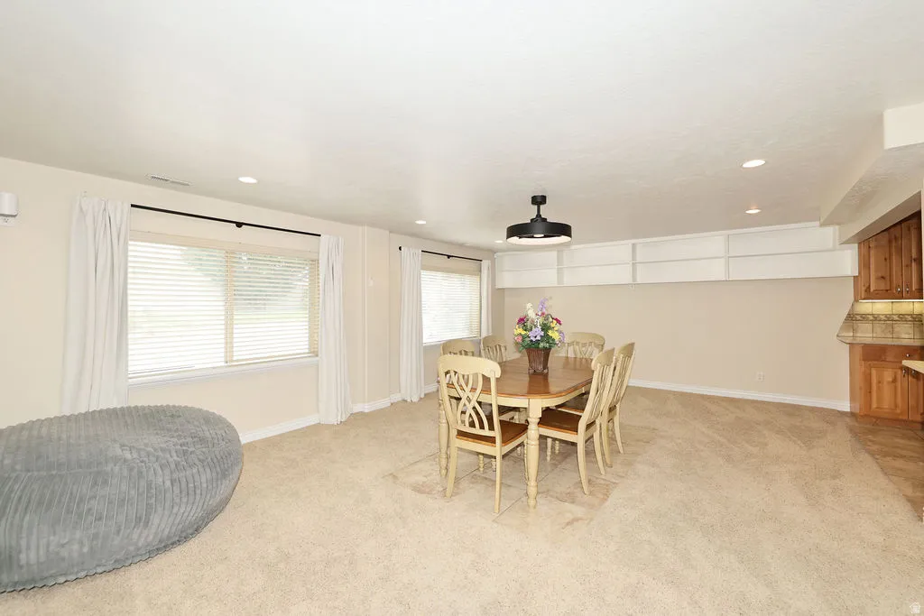 Spacious room with plush carpet flooring and recessed lighting