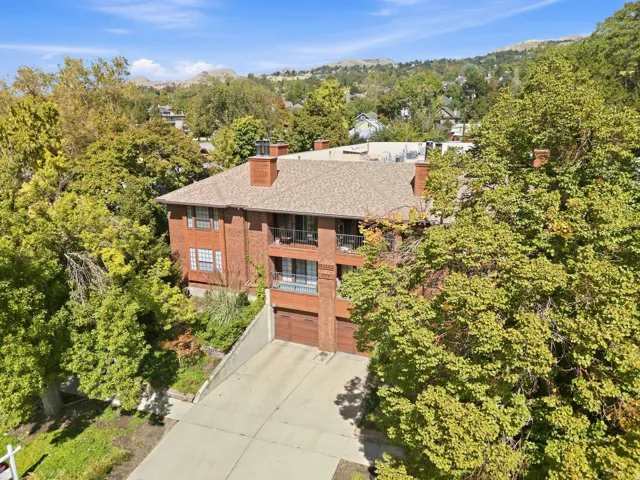 Brick exterior with multiple balconies and a multi-car garage