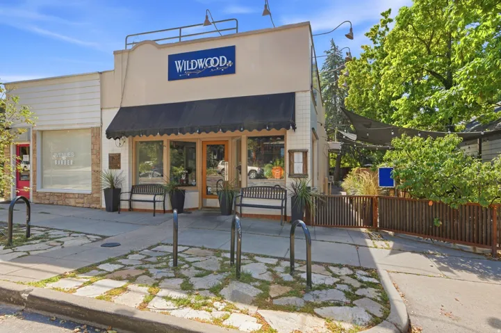 Commercial storefront with a black awning and large display windows