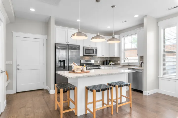 Modern kitchen with white cabinetry and stainless steel appliances