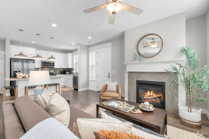 Living area featuring a fireplace with a tile surround and a white mantel