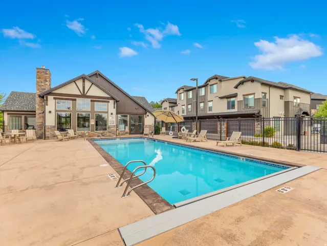 Outdoor swimming pool with integrated steps, surrounded by a concrete deck
