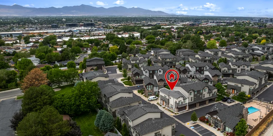Aerial perspective showcasing a multi-unit property within a community featuring an outdoor pool