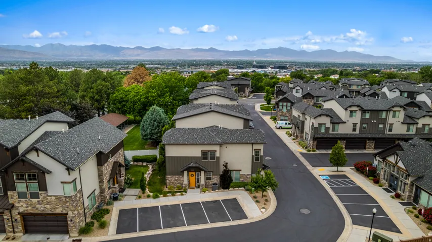 Modern townhome community featuring diverse exterior finishes including stone accents and horizontal siding