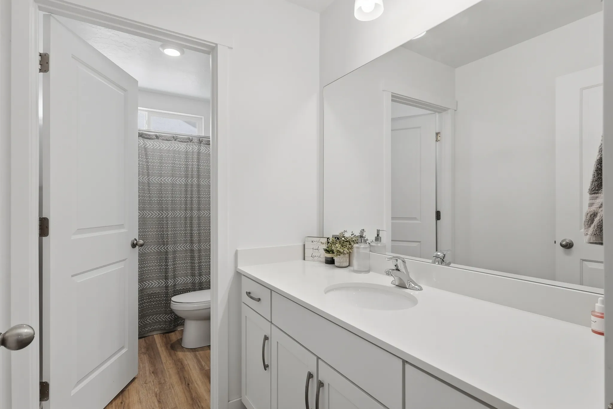 Spacious bathroom vanity featuring a single basin sink, chrome faucet, and expansive countertop