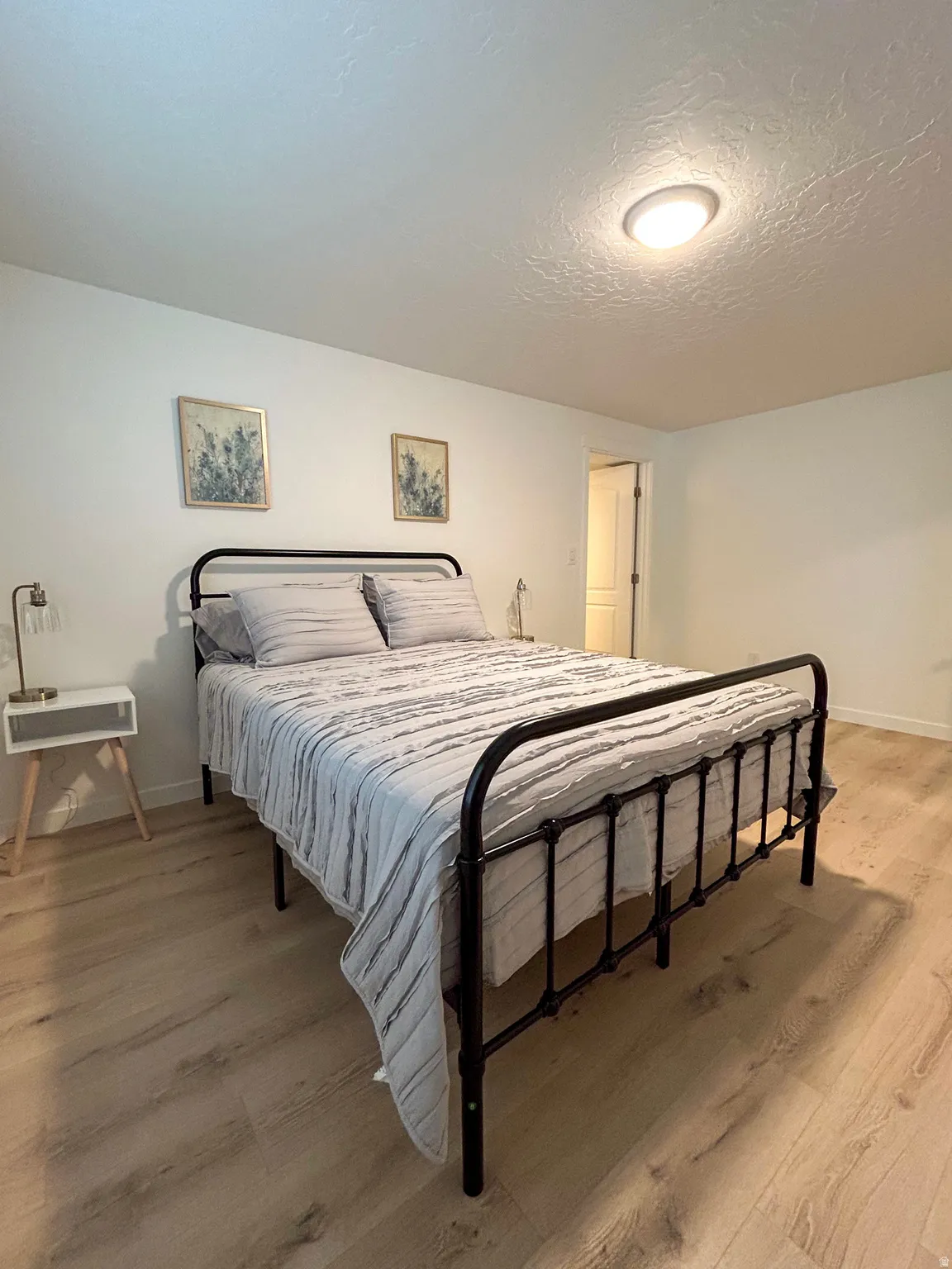 Light wood-finish flooring complements crisp white walls