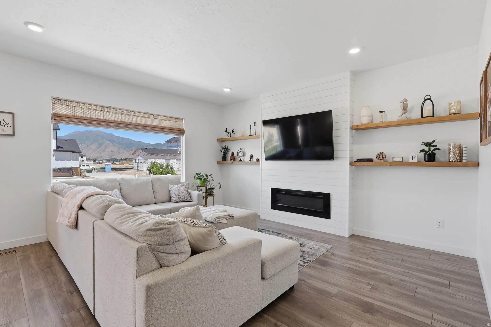 Living space featuring wood-finish flooring and recessed lighting