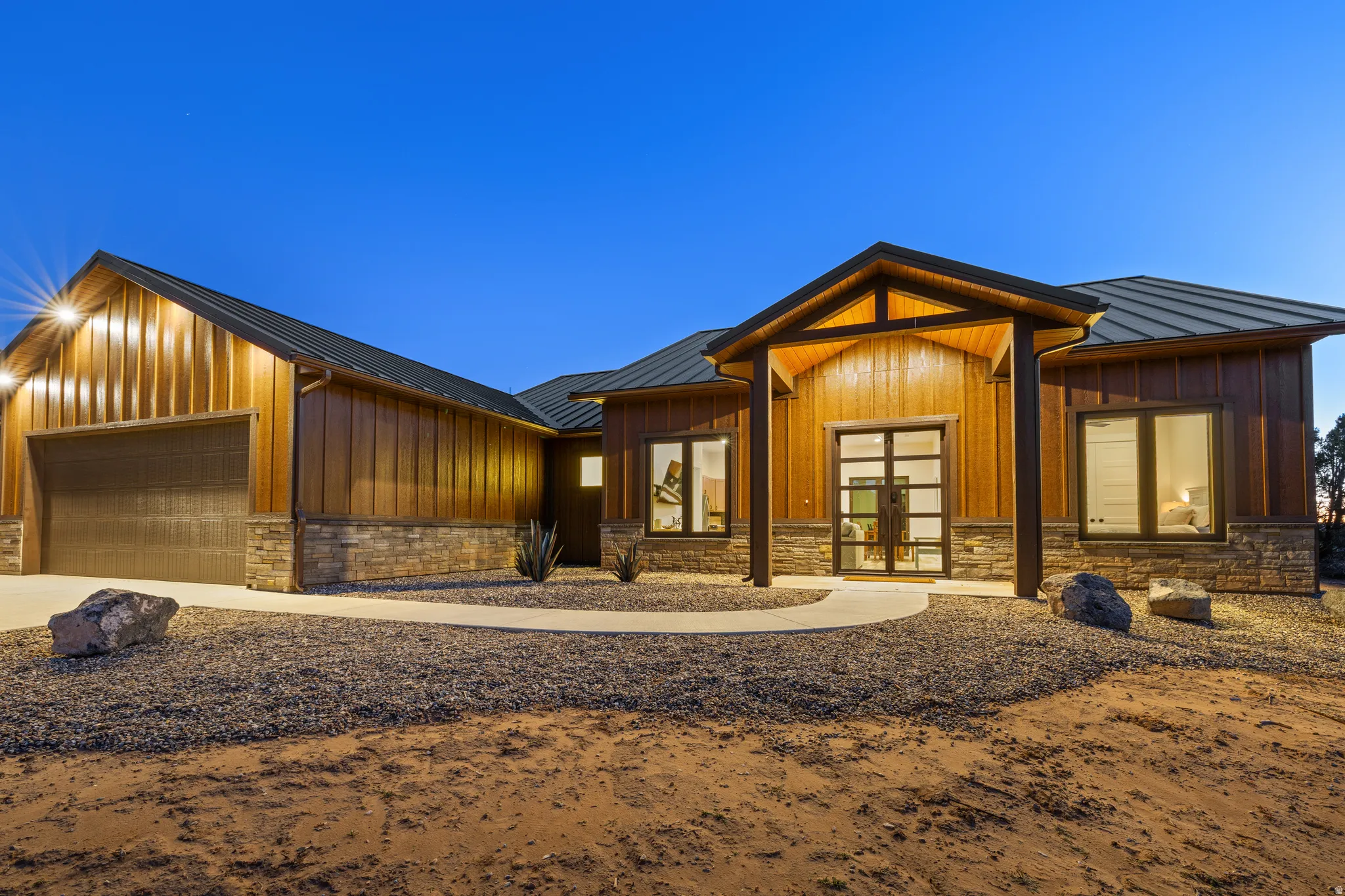 Modern rustic exterior featuring vertical wood-finish siding and stone accents
