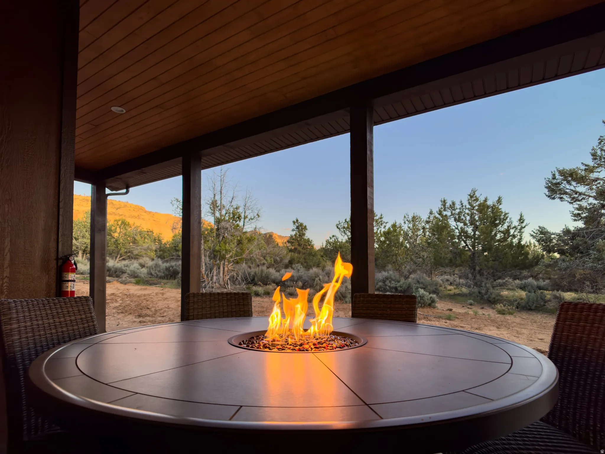 Covered patio featuring a fire pit table