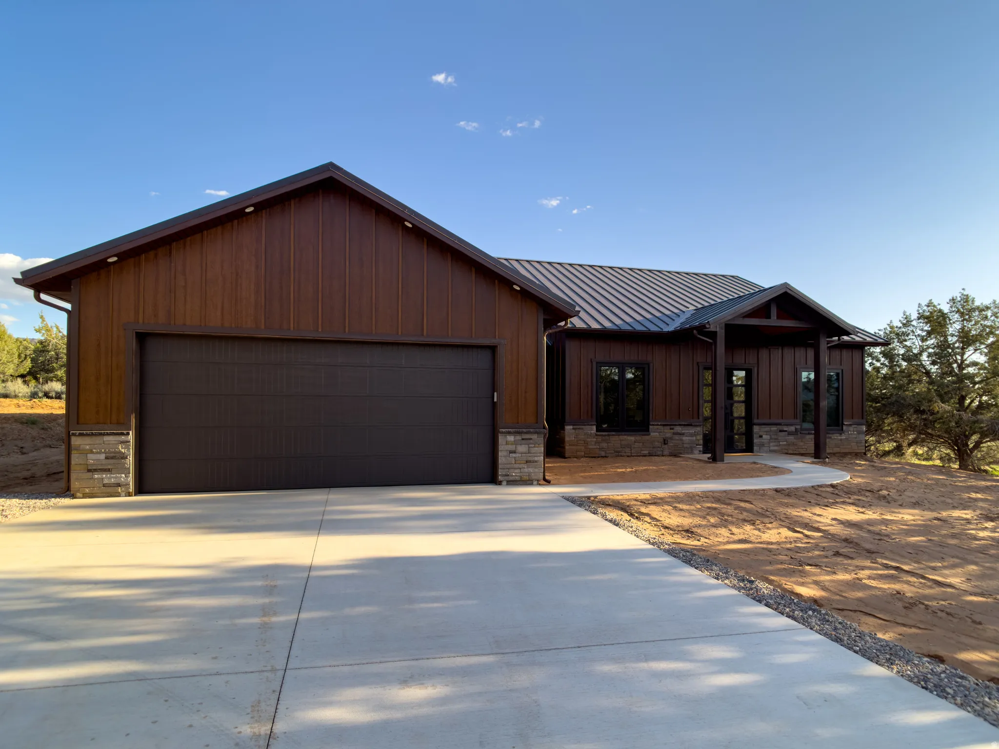 Contemporary-style residence featuring a metal roof and wood-look siding