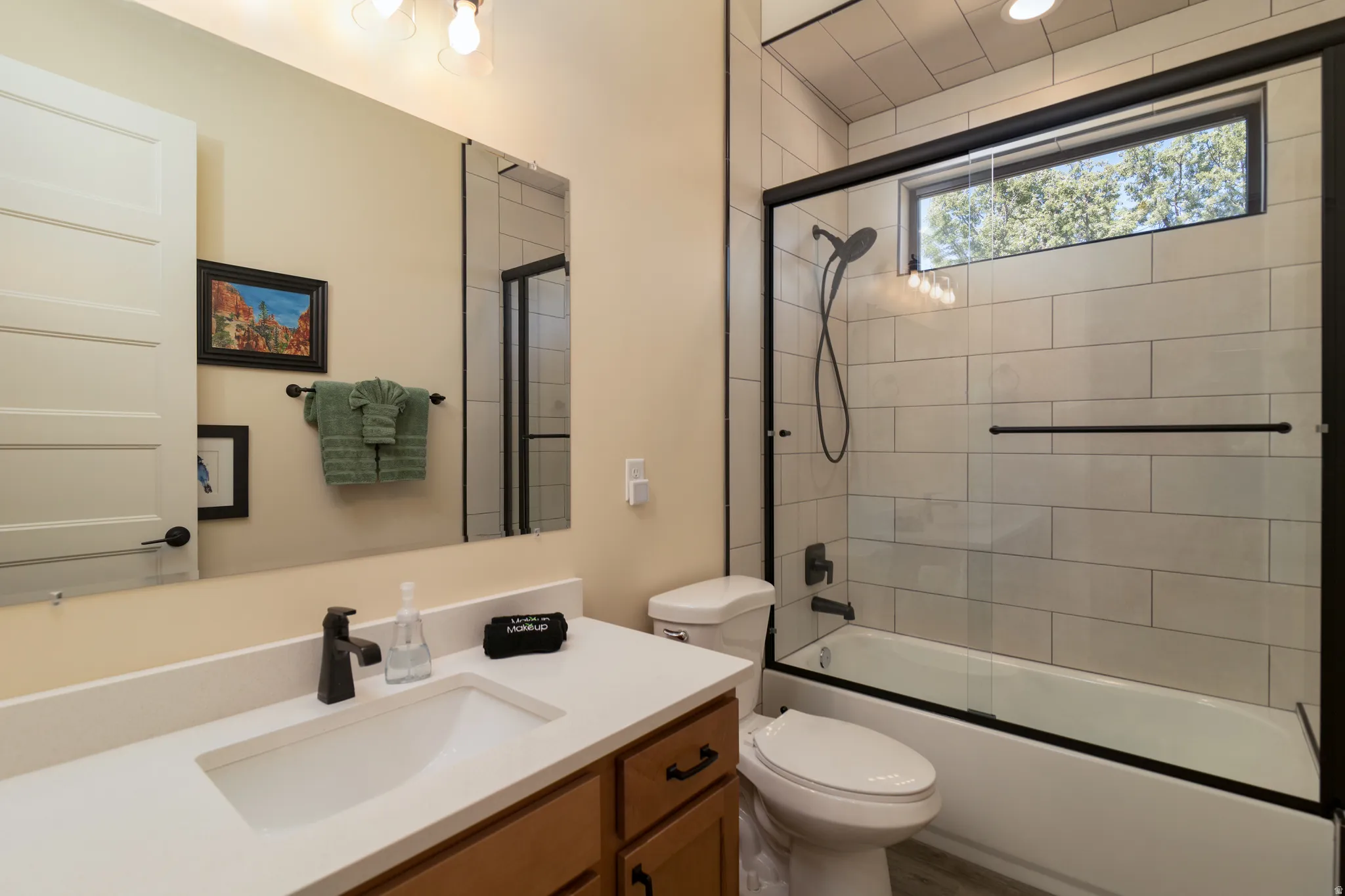 Bathroom 2 featuring a wood-finish vanity with a white countertop and integrated sink