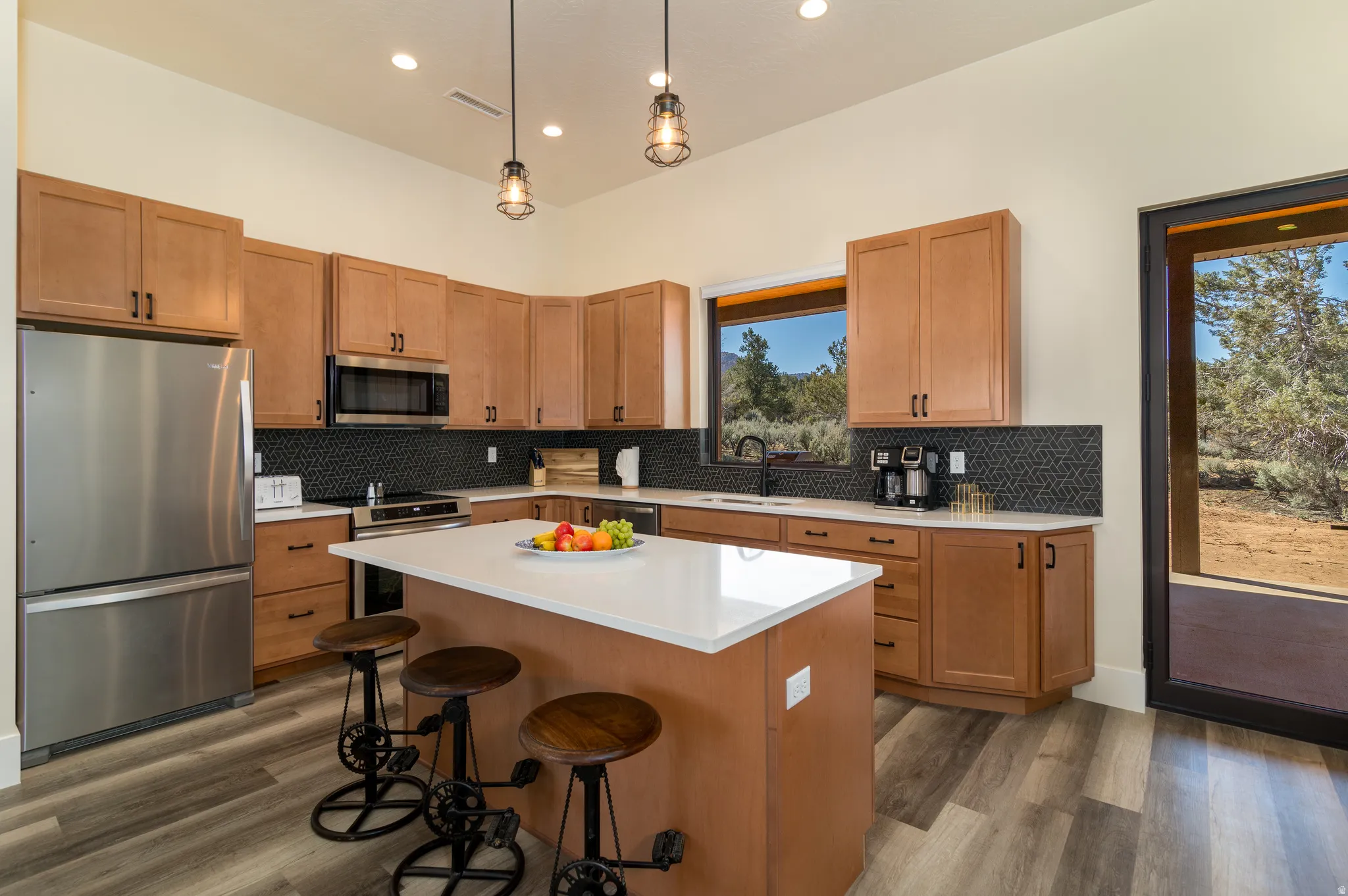 Modern kitchen featuring a central island with a solid surface countertop
