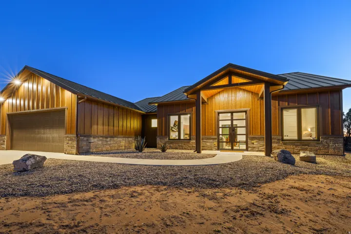 Modern rustic exterior featuring vertical wood-finish siding and stone accents