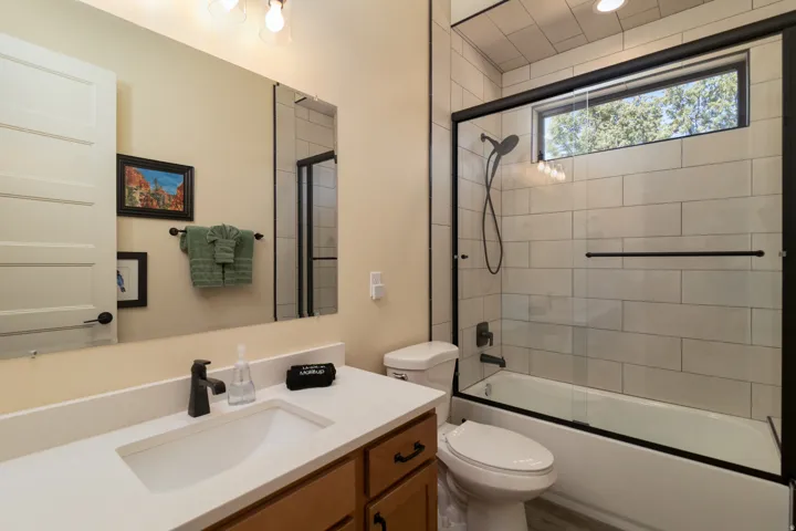 Bathroom 2 featuring a wood-finish vanity with a white countertop and integrated sink