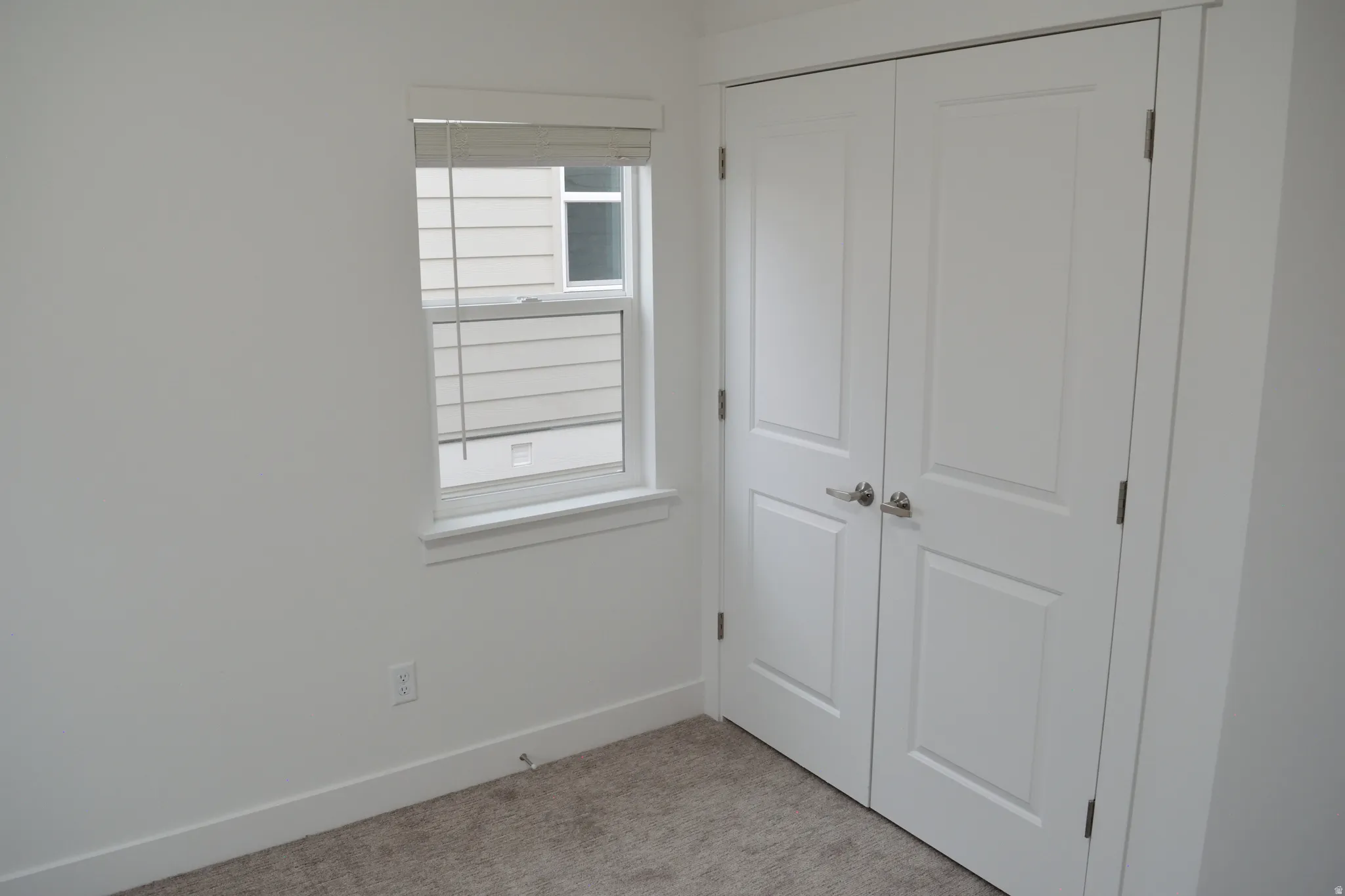 White paneled bifold doors with brushed nickel hardware
