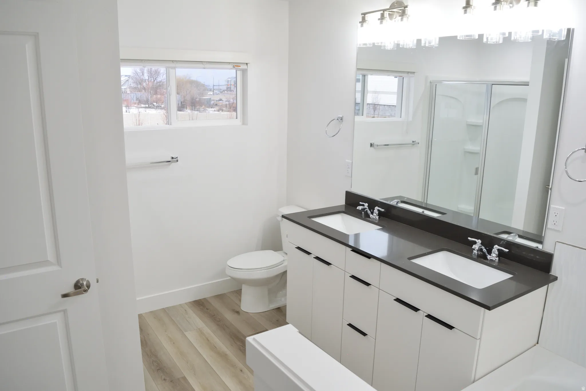 Double vanity with sleek dark countertops and undermount sinks