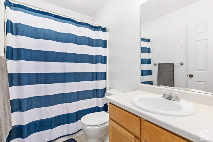 Full bathroom featuring a single-sink vanity with wood-finish cabinetry, a white countertop, and an integrated basin