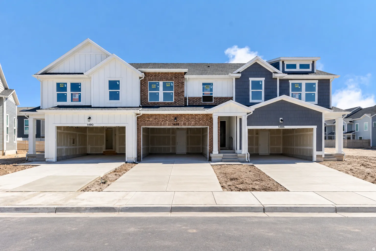 Multi-level townhome exteriors featuring brick and siding finishes