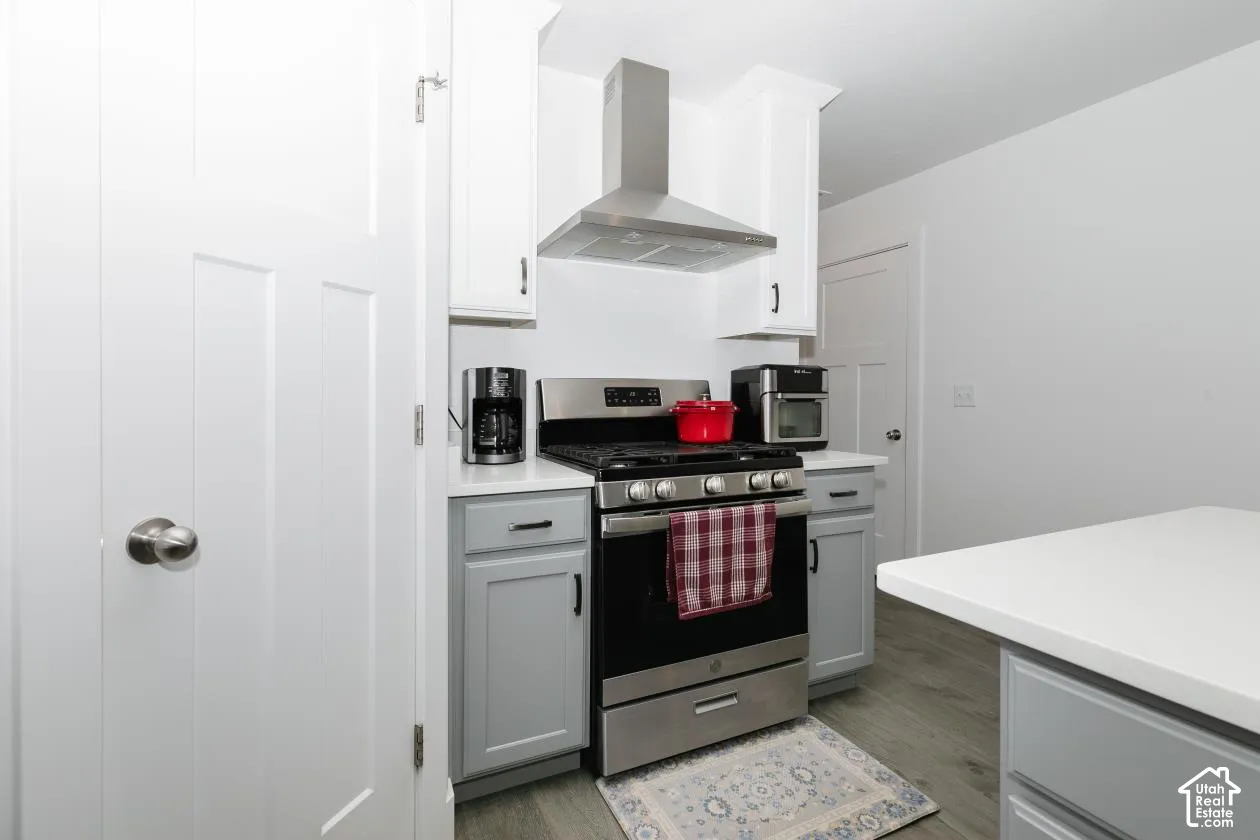 Modern kitchen featuring stainless steel appliances, white upper cabinetry, and contrasting gray lower cabinetry
