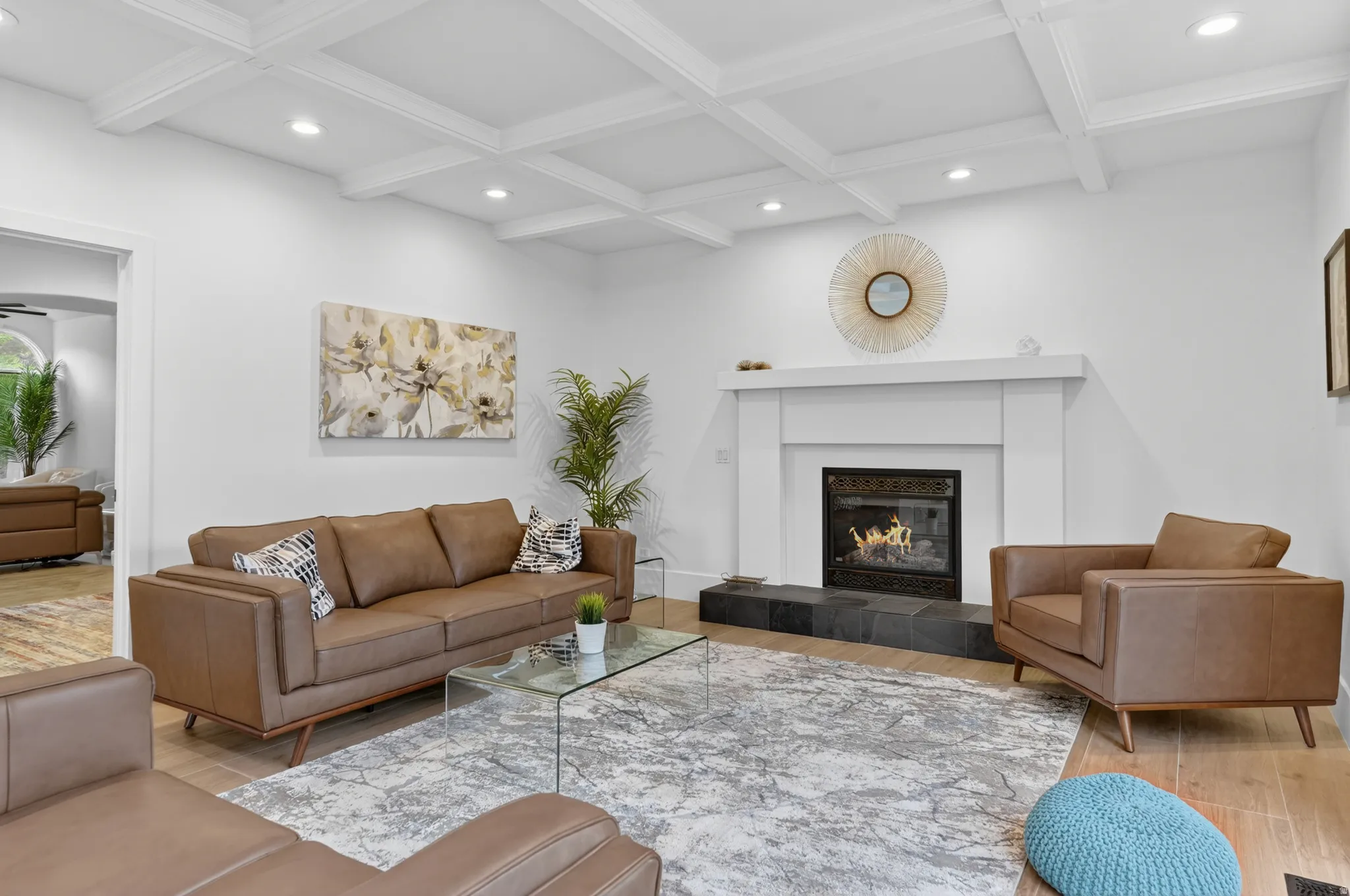 Living area featuring a coffered ceiling, recessed lighting, and wood-finish flooring