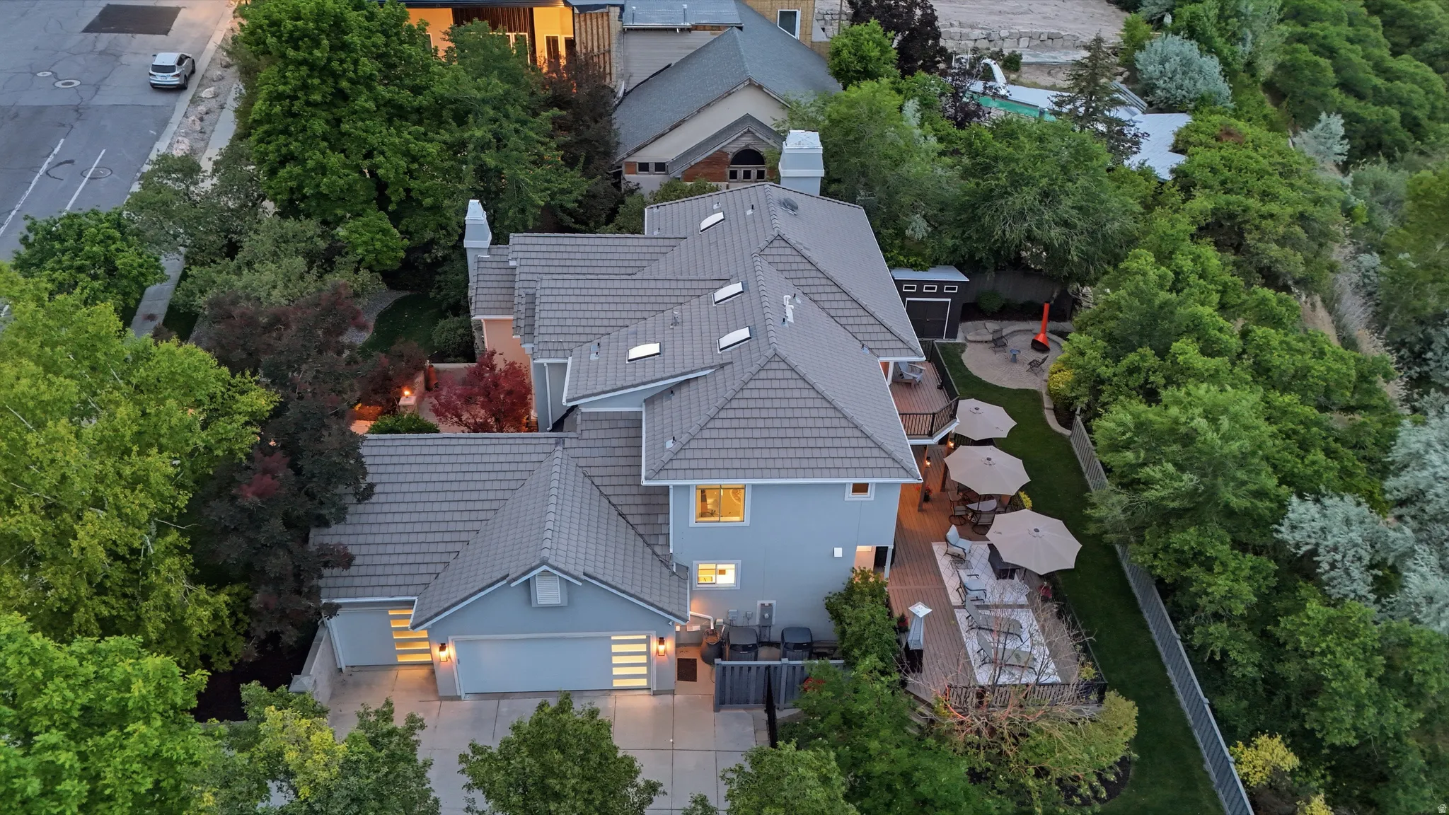 Expansive property with a multi-level roofline, light blue siding, and an attached two-car garage
