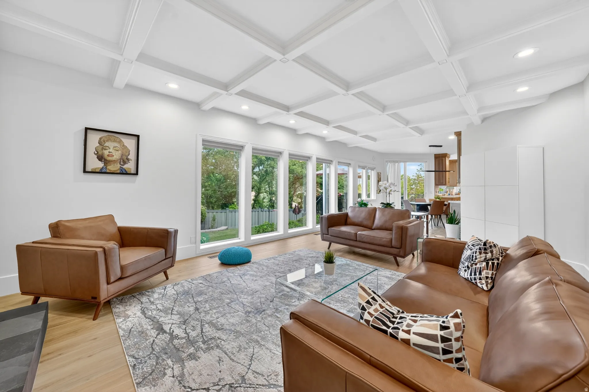 Living area featuring a coffered ceiling with recessed lighting