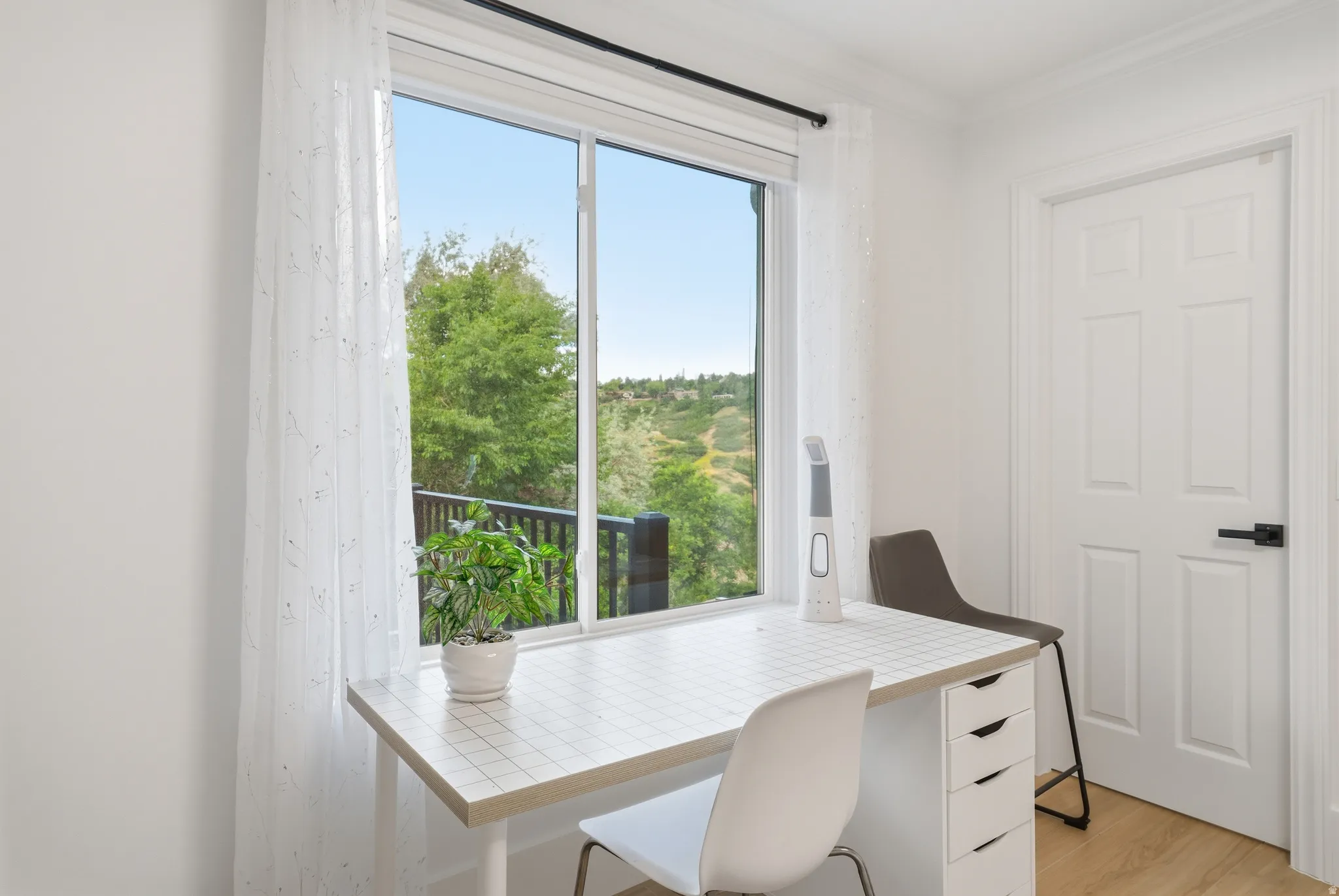 Expansive window with roller blinds offering natural scenery