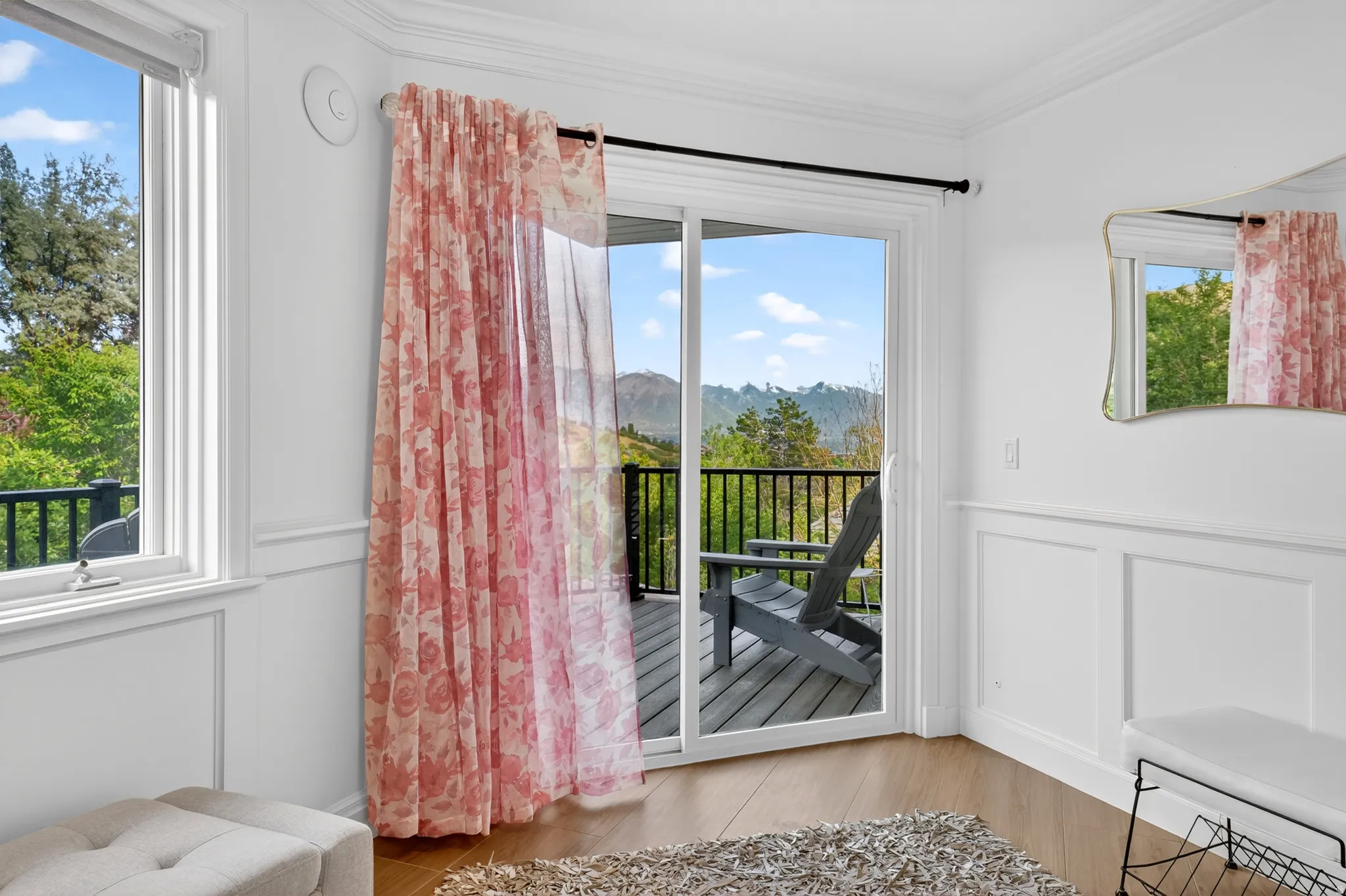Sliding glass door opening to an outdoor deck with black metal railing