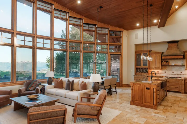 Great room featuring expansive, multi-story windows, wood-finish vaulted ceilings, and tile flooring