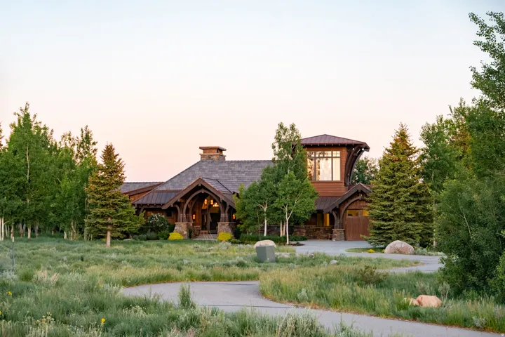 Rustic architectural style with wood siding and stone accents