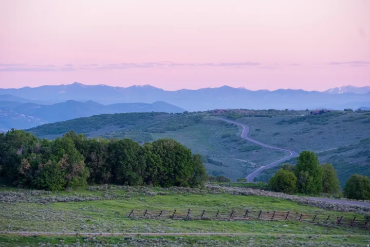 Expansive mountain landscape with a winding paved road
