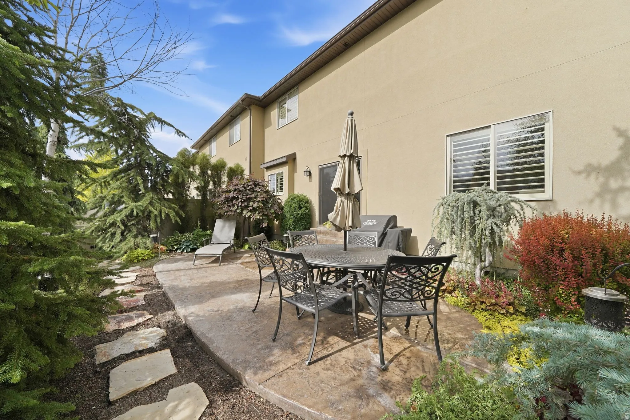Exterior stucco-finish facade with a concrete patio