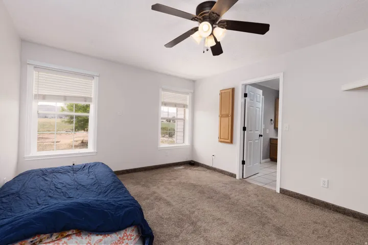 Light-filled room featuring neutral wall paint and plush carpeting
