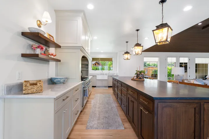 Spacious kitchen featuring a large central island with rich wood cabinetry and ample countertop space
