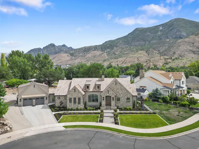 Stone and stucco exterior with a cedar shake roof